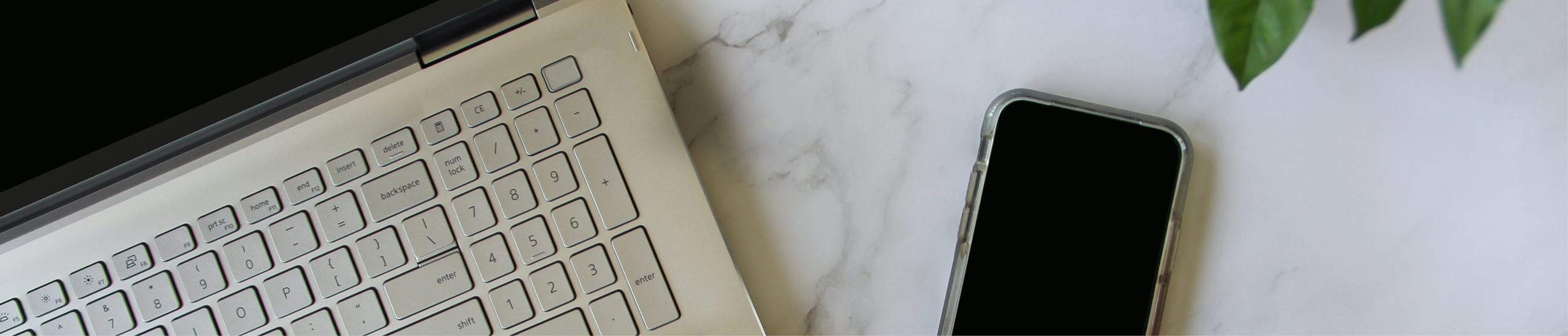 Overhead view of cell phone and laptop